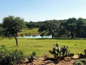 Escape to a serene oasis surrounded by lush greenery and a tranquil body of water.