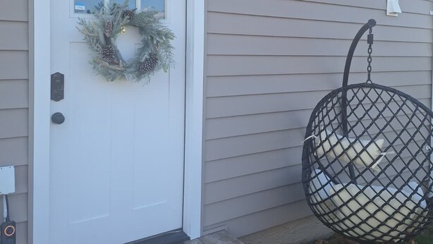 A house with a white front door, a wreath, and a Santa-themed mat. - Private, Quiet 1 Bedroom in Amityville (Amityville)
