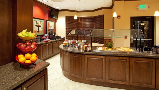 A kitchen area with a central island, a fruit bowl, and a buffet setup. - 2 Bedroom | Free Wi-Fi + Breakfast, Gym Access (Columbia)
