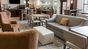 A hotel lobby with a seating area, a bar, and a television. - 1 Bedroom Suite | FREE Breakfast + Laptop-friendly (Stow)