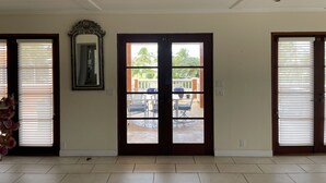 A spacious room with a large sliding glass door leading to an outdoor patio area. - Walk to the beach (Christiansted)