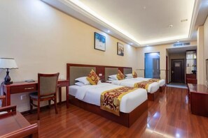 A hotel room with two beds, a desk, and a chair. - Yin He Hotel (Zunyi)
