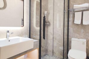 A modern bathroom with a glass-enclosed shower, a white sink, and a toilet. - Guyue Hotel (Shengzhou Wuyue Plaza Branch) (Shengzhou)