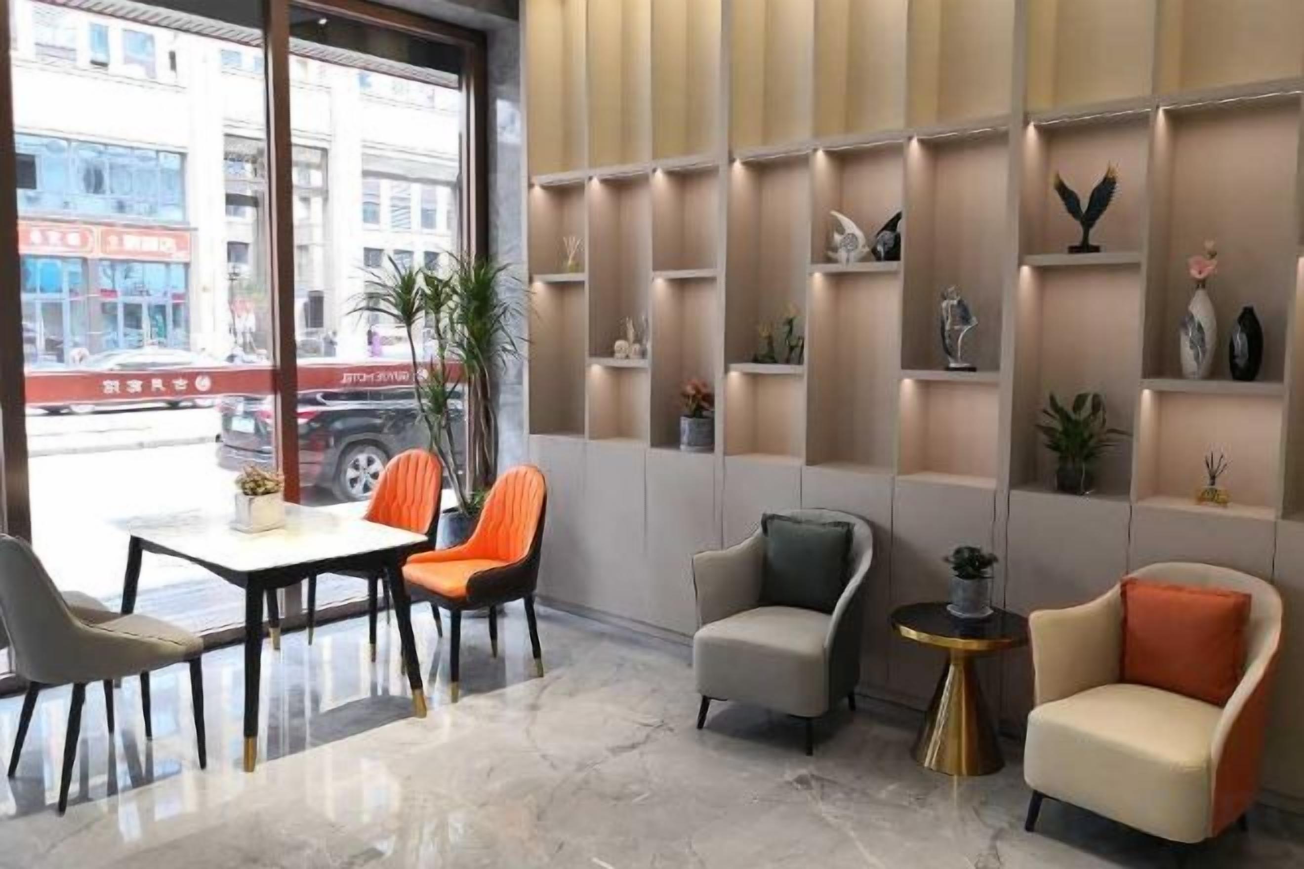 A modern interior with a seating area, a table, and a view of the street outside.