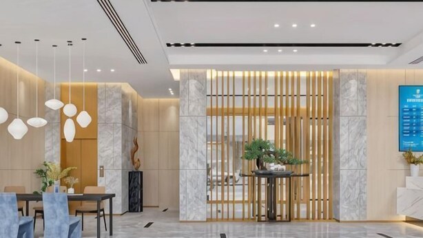 A modern lobby with a reception desk, seating area, and a decorative plant. - Guyue Hotel (Shengzhou Wuyue Plaza Branch) (Shengzhou)