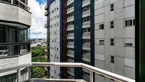 A high-rise building with multiple balconies and a view of a cityscape. - Rooftop Pool with Sea and Bridge Views #CA22 (Florianópolis)