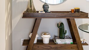 A wooden console table with a large mirror, a potted plant, and decorative items. - 350m Public Market | Walkable #CA10 (Florianópolis)