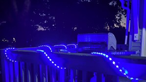 A deck with blue LED lights, a grill, and a propane tank. - Fun Haven! 2 Units in 1 house for private gatherings and games (South Haven)