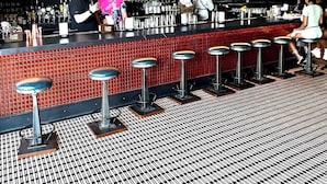A bar area with stools, a counter, and a television screen. - Close to Old Town Alexandria And All Things DC (Alexandria)