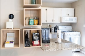 A kitchen with white cabinets, a microwave, a coffee maker, and a blender on the counter. - LovableStays Del Ray House: 3 Kings, Yard, Dogs OK (Alexandria)