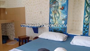 A standard aircon room with a bed, pillows, a painting, and a towel sculpture. - Danielas Place (Angeles City)