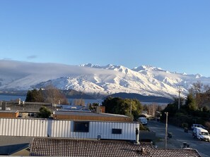 Enjoy a peaceful retreat with a satellite dish and chimney, surrounded by snow-capped mountains.