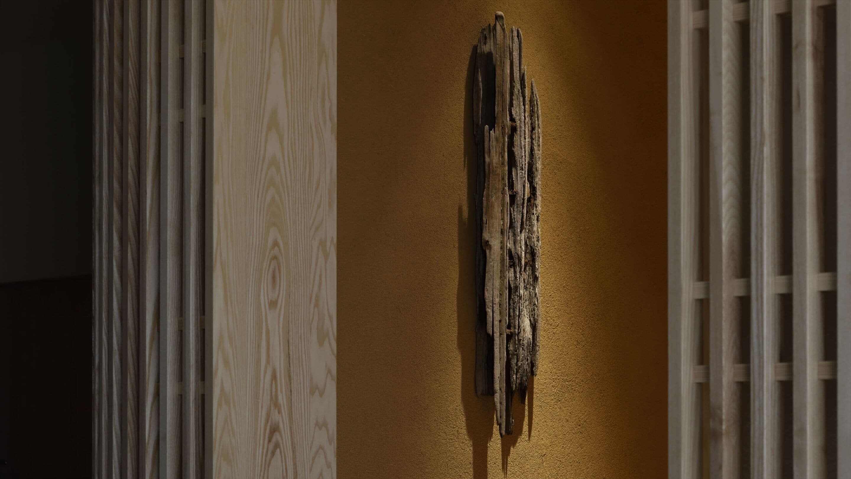 A wooden wall with a distressed texture and a vertical wooden beam.