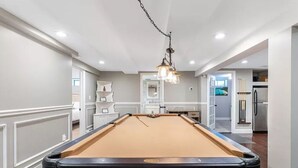 A pool table in a room with white walls and wooden flooring. - Perfect summer getaway in Hampton Bays. Last 2 weeks of Summer, still available! (Hampton Bays)