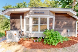 Welcome to the charming SEA HOUSE, featuring a cozy porch and corner window.
