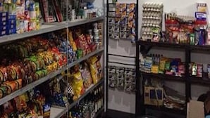 A storage room with shelves stocked with various food items and boxes. - King Henrys Transient House (Bantay)