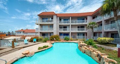 Coastal Bend condo with water views, dock, pool, sun deck, balcony, & W/D