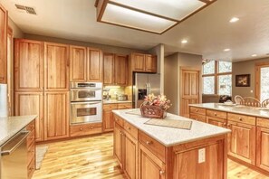 Enjoy cooking in this well-equipped kitchen with a central island and ample counter space.