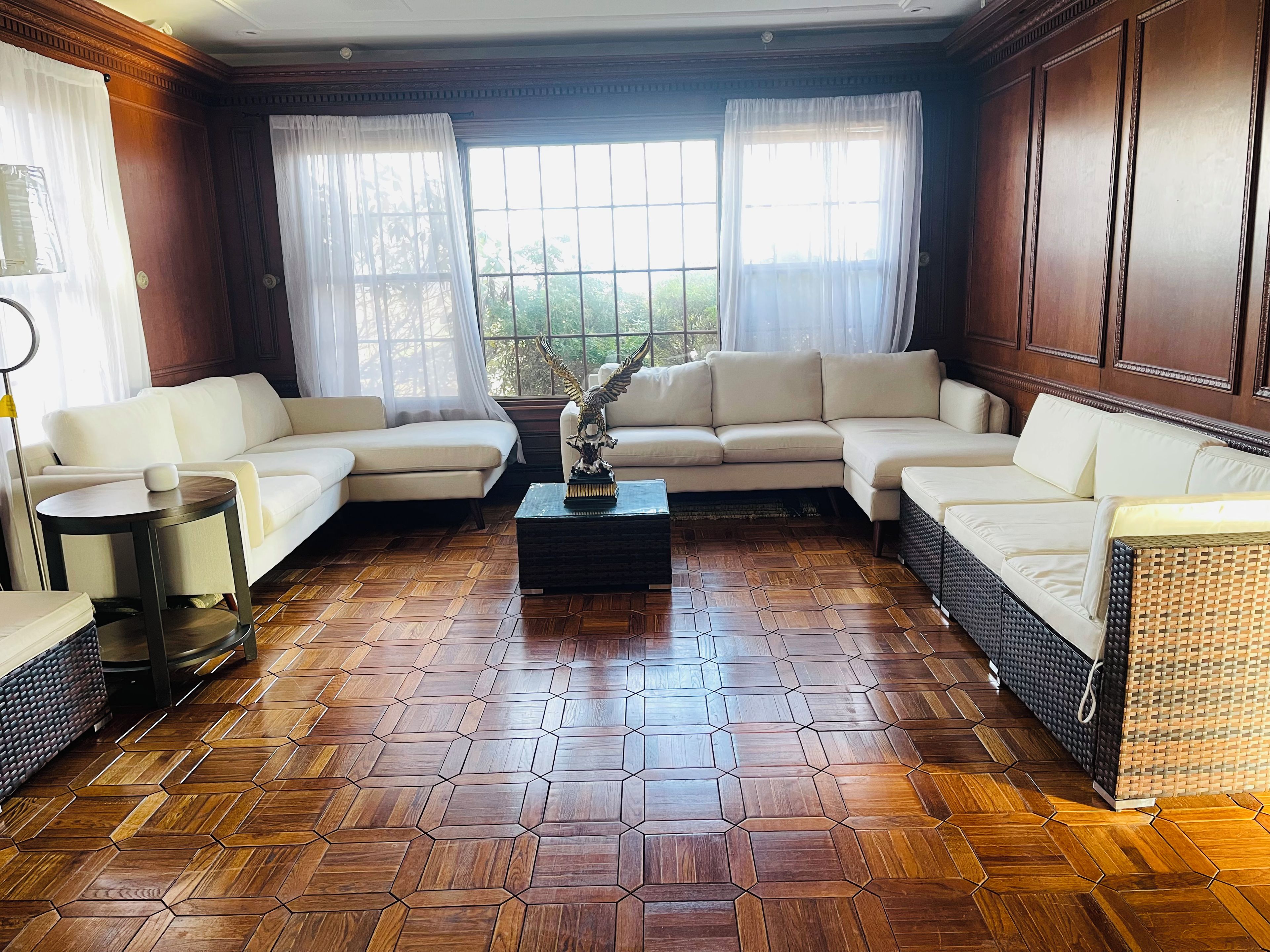 A living room with a sectional sofa, a coffee table, and a decorative sculpture.
