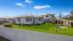 A single-story mobile home with a front porch and a small front yard. - Convenient Location Cosy Home (Garbutt)