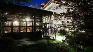A building with a covered outdoor seating area and a traditional architectural style. - La Boheme (Bucharest)