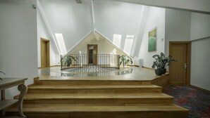 A spacious loft with a high ceiling, skylights, and a central open area with a railing. - La Boheme (Bucharest)