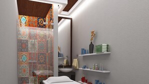 A modern bathroom with a bed, a sink, and shelves with toiletries. - hotel mari aai residency (Panvel)
