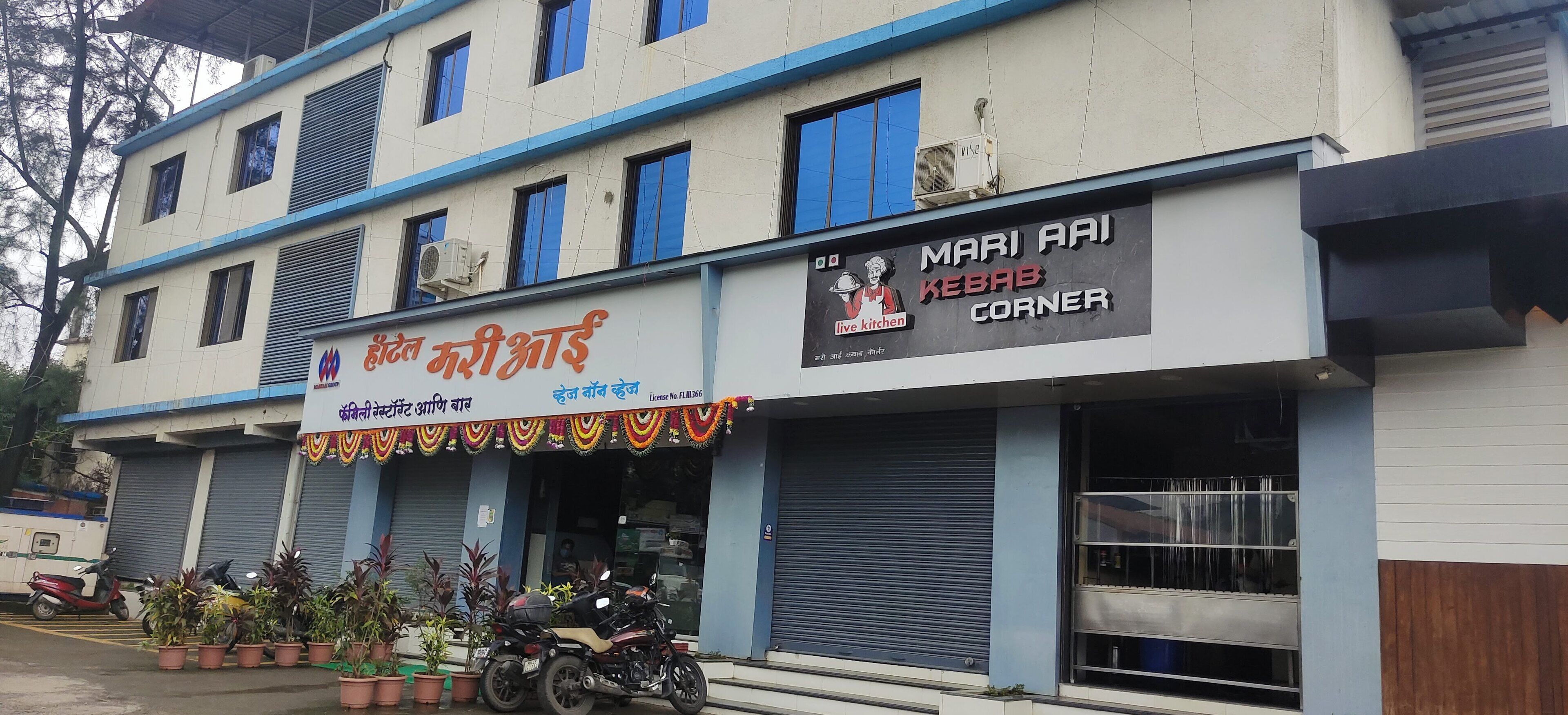 A building with a sign for "Mari Aai Kebab Corner" and another sign for "Kavita Mistry's".