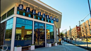 A modern building with a glass facade and the name "BEETLECAT" displayed above the entrance.
