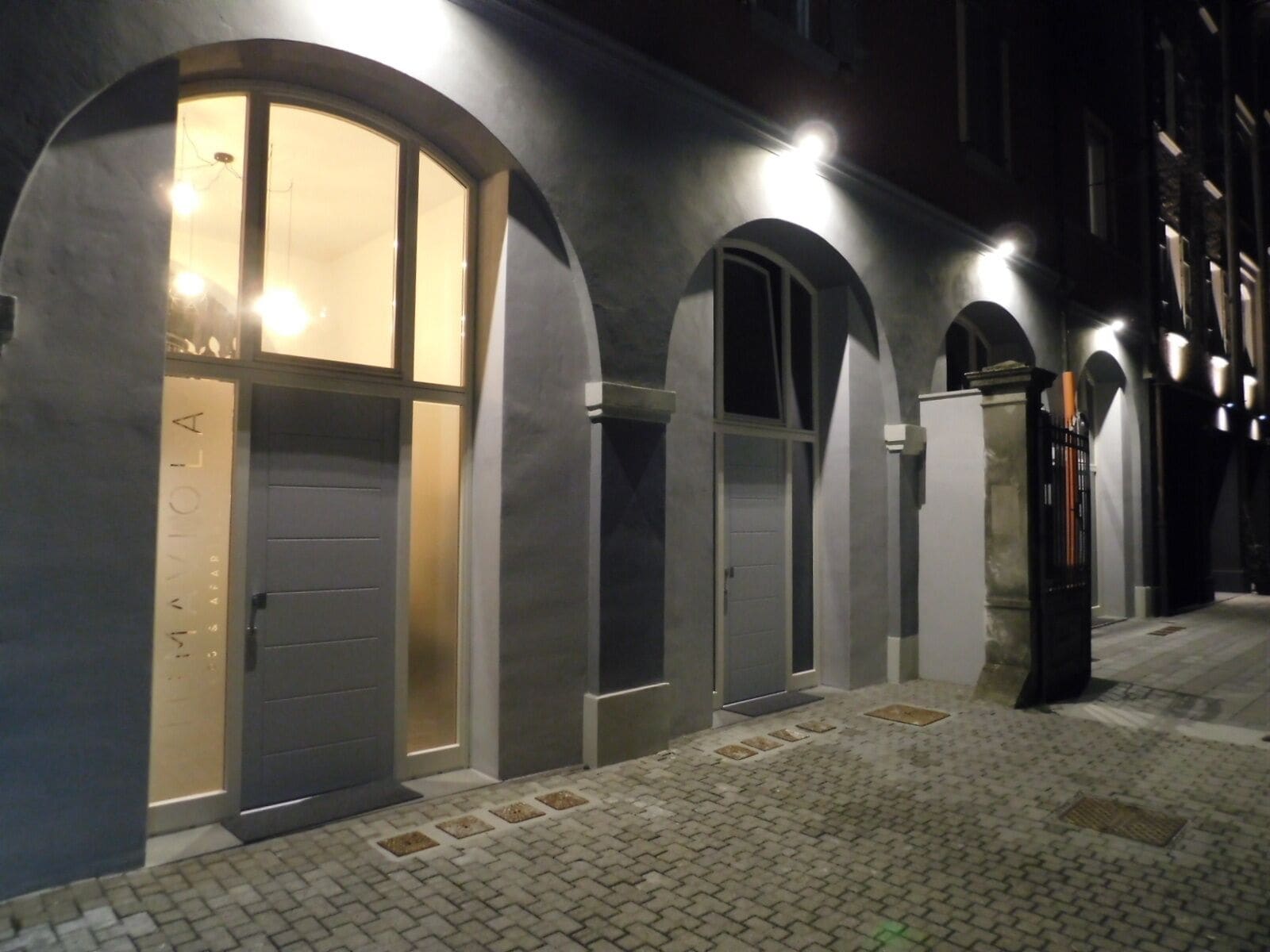 A building with arched doorways and a tiled ground.