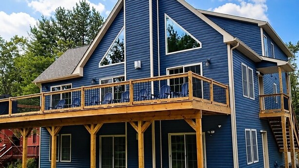 A two-story building with a balcony and a covered deck area. - The Fawn Château w/ Game Room & sauna  (Lake Ariel)