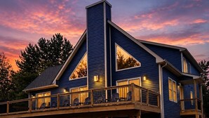 A two-story house with a balcony, large windows, and a chimney. - The Fawn Château w/ Game Room & sauna  (Lake Ariel)