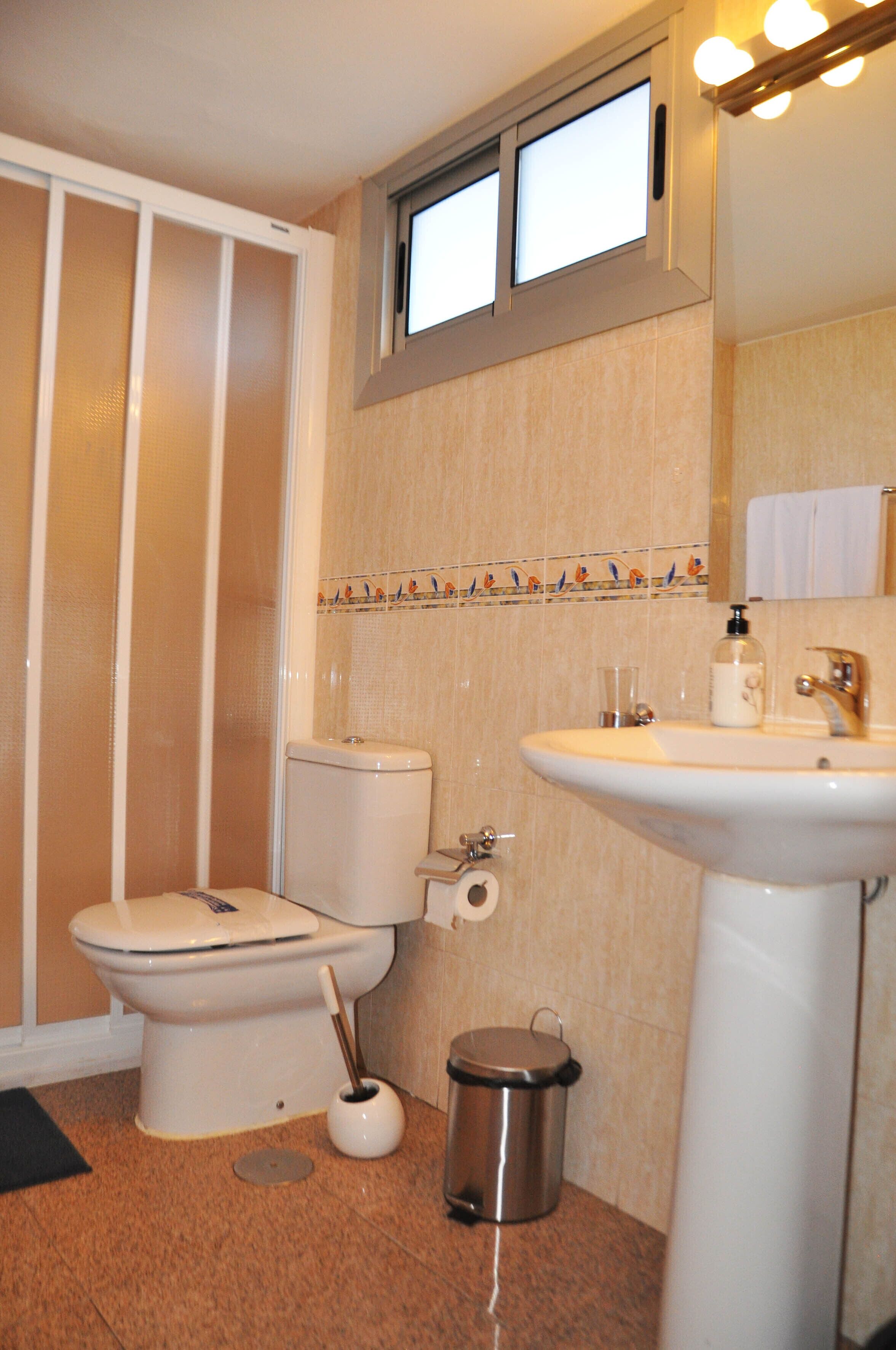 Ein Badezimmer mit Toilette, Waschbecken und Dusche.