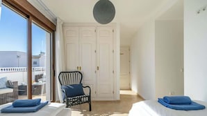 A hotel room with two beds, a large window, a balcony, and a chair. - Pool Penthouse in La Cala by Costarentals - Ref 19 (Las Lagunas de Mijas)