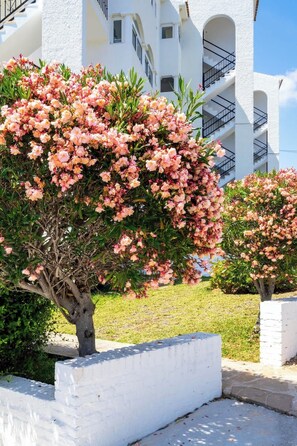 A building with white exterior walls and multiple balconies. - Lovely Apt with Pool by Costarentals - Ref 07 (Málaga)