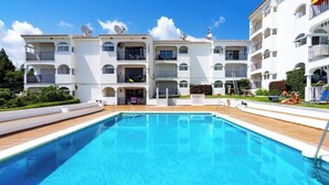 A modern building with a swimming pool, multiple balconies, and a well-maintained garden. - Lovely Apt with Pool by Costarentals - Ref 07 (Málaga)