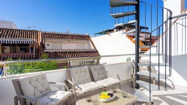 A rooftop terrace with outdoor seating, a dining table with fruit, and a spiral staircase. - Beachclose Penthouse by Costarentals - Ref 15 (Fuengirola)