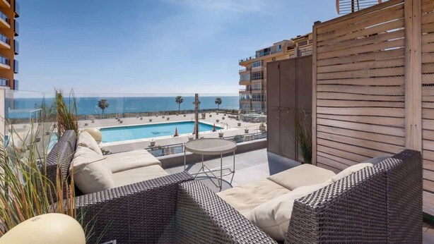 A balcony with wicker furniture, a pool, and a view of the ocean. - Modern sea view rooftop by Costarentals - Ref 116 (Fuengirola)
