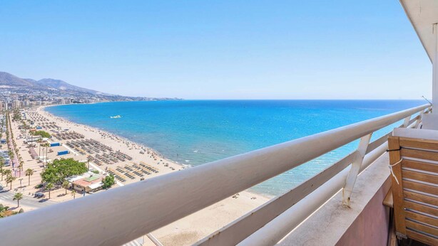 A coastal view from a balcony with a beach, clear sky, and distant mountains. - Beachfront Stella Maris by Costarentals - Ref 36 (Fuengirola)