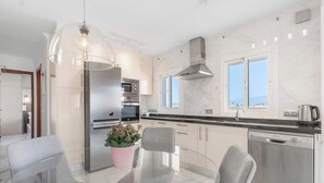 A modern kitchen with a built-in oven, microwave, and stainless steel appliances. - Beachfront Stella Maris by Costarentals - Ref 36 (Fuengirola)