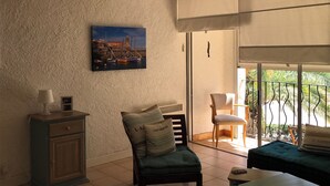 A room with a view of a harbor, a chair, a table, and a cabinet. - A 200 M de la Plage (Argelès-sur-Mer)