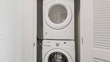 A stacked washer and dryer unit in a laundry room.