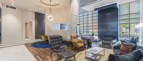 A modern lobby with a curved ceiling, seating area, and large windows.