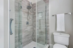 Bathtub, hair dryer, towels, shampoo