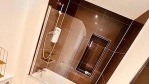 A modern bathroom with a toilet, sink, and shower area. - George and Dragon Hotel (High Wycombe)
