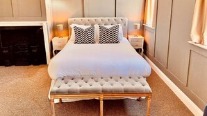 A neatly arranged bedroom with a large bed, two bedside tables, and a bench. - George and Dragon Hotel (High Wycombe)