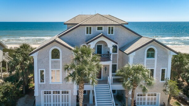 A two-story house with a balcony, a garage, and a driveway leading to the entrance.