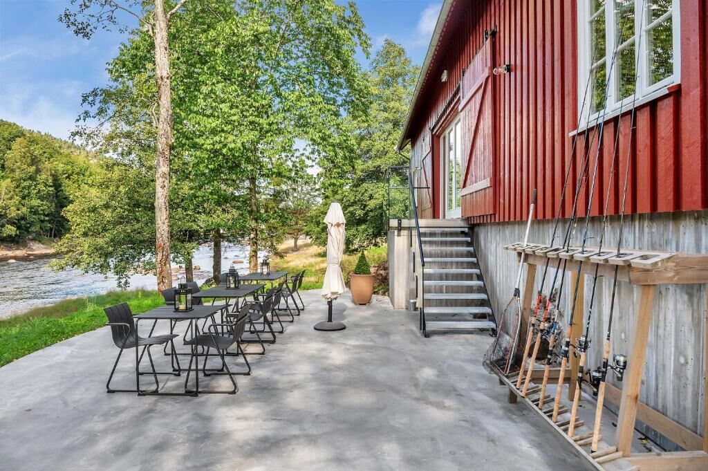 A red building with outdoor seating and fishing equipment.