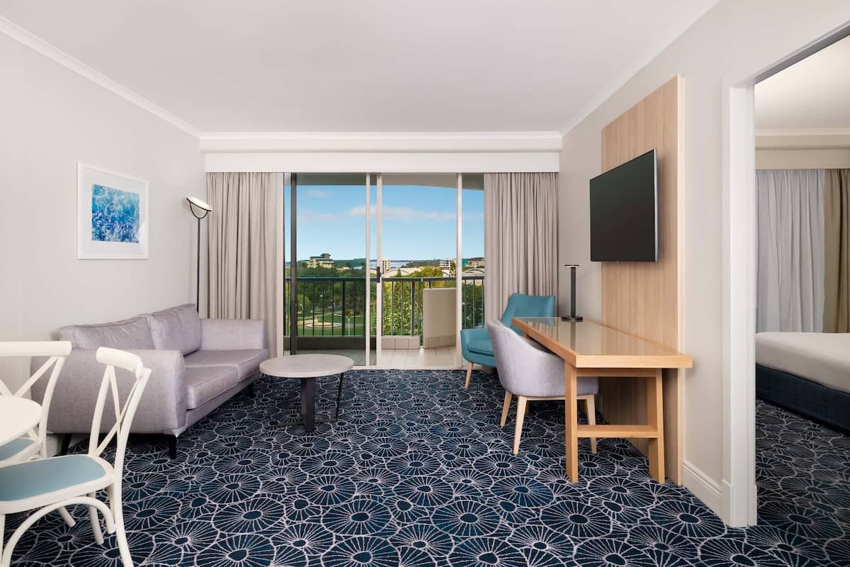 Escritorio, tabla de planchar con plancha y ropa de cama