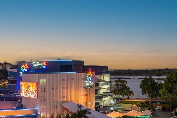 A building with a large illuminated sign reading "Tim Hortons clubs & resorts" and a large screen displaying an image. - The Sebel Twin Towns Coolangatta (Tweed Heads)